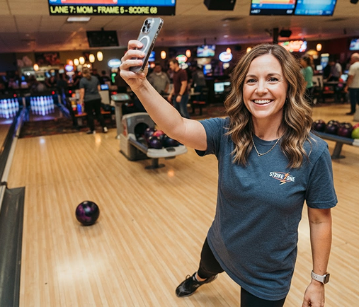 A guest taking a selfie on the lanes at Woodmere Lanes