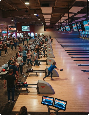 Bowlers enjoying open bowling with cosmic lighting